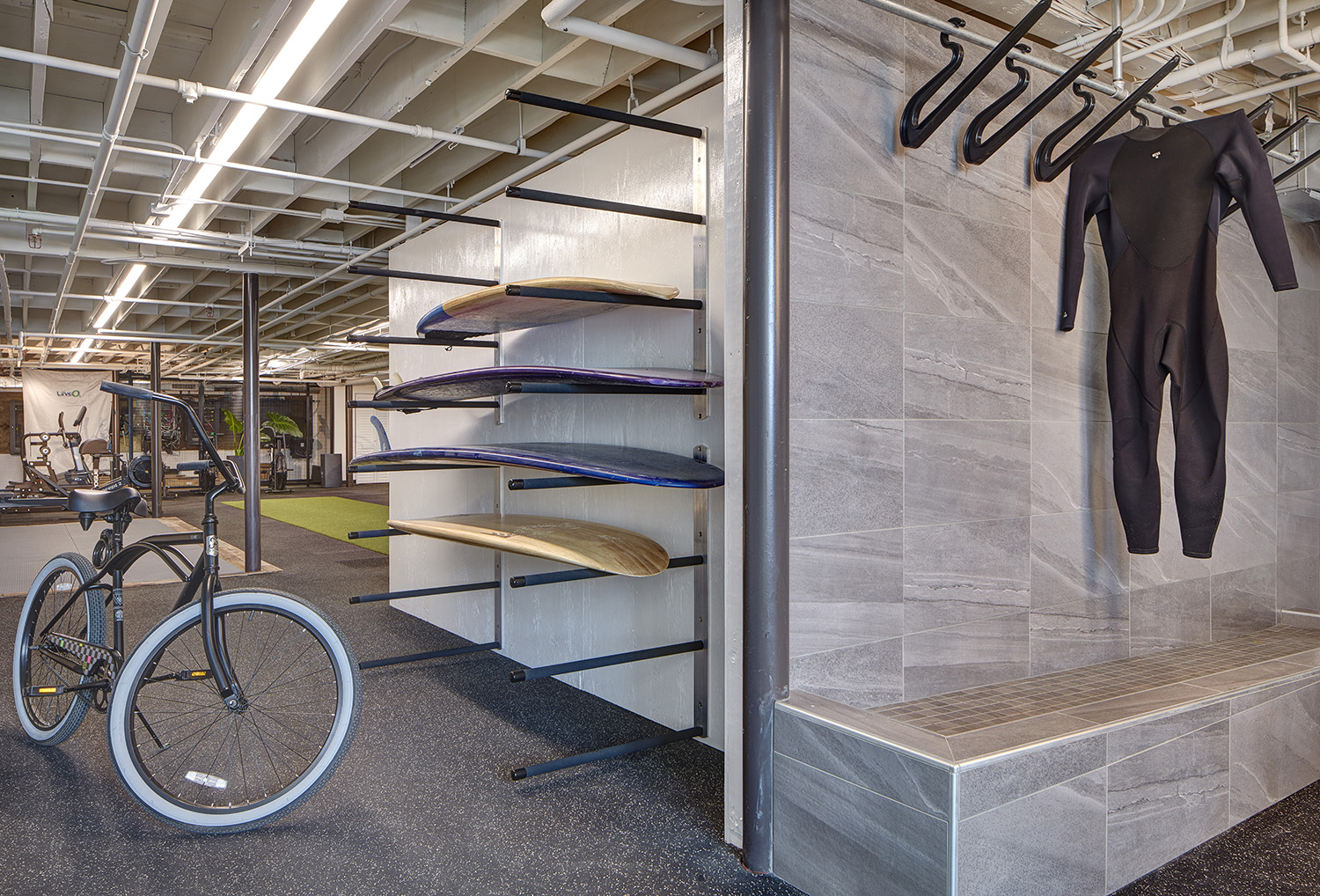 Modern student housing in San Diego with wellness features like a gym, surfboard storage and can also include smart tech features like keyless entry, charging stations, and relaxed seating